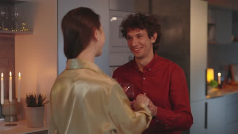 couple sharing a romantic evening with wine in the kitchen