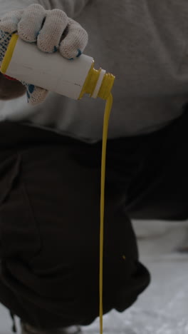 painter using paint roller and putty knife