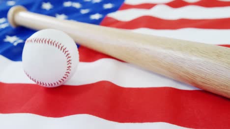 baseball and baseball bat on an american flag