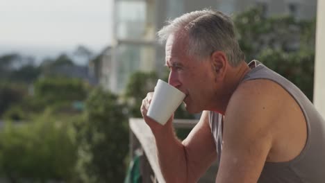 senior man drinking coffee on terrace