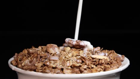 milk cascades over vibrant cereal in a bowl, creating a dynamic and colorful breakfast scene