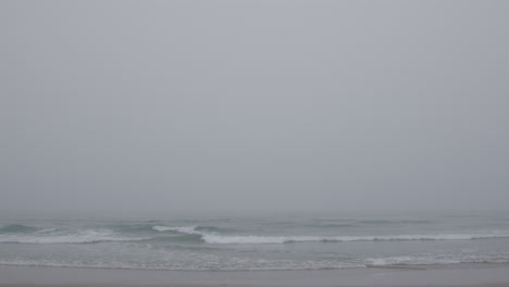 man walking in foggy ocean waves