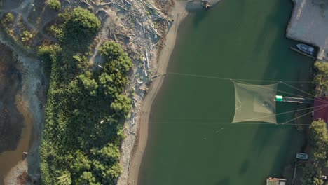 Aerial-view-of-fishing-huts-in-the-river,-Lido-di-Dante,-Fiumi-Uniti,-Ravenna-near-Comacchio-valley