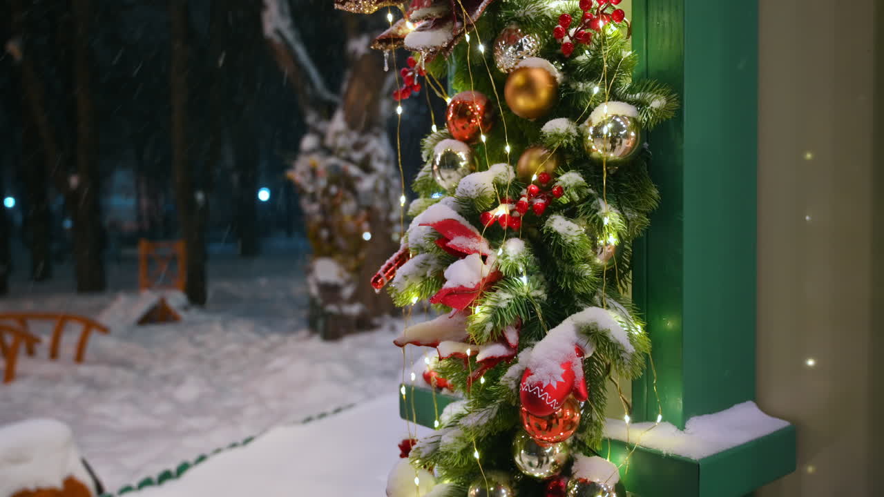 Christmas decorations in the park during snowfall. Winter evening