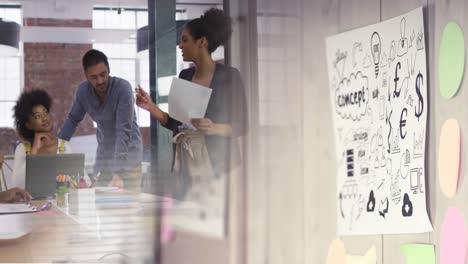 animation of wall with concept on paper over diverse group of business people