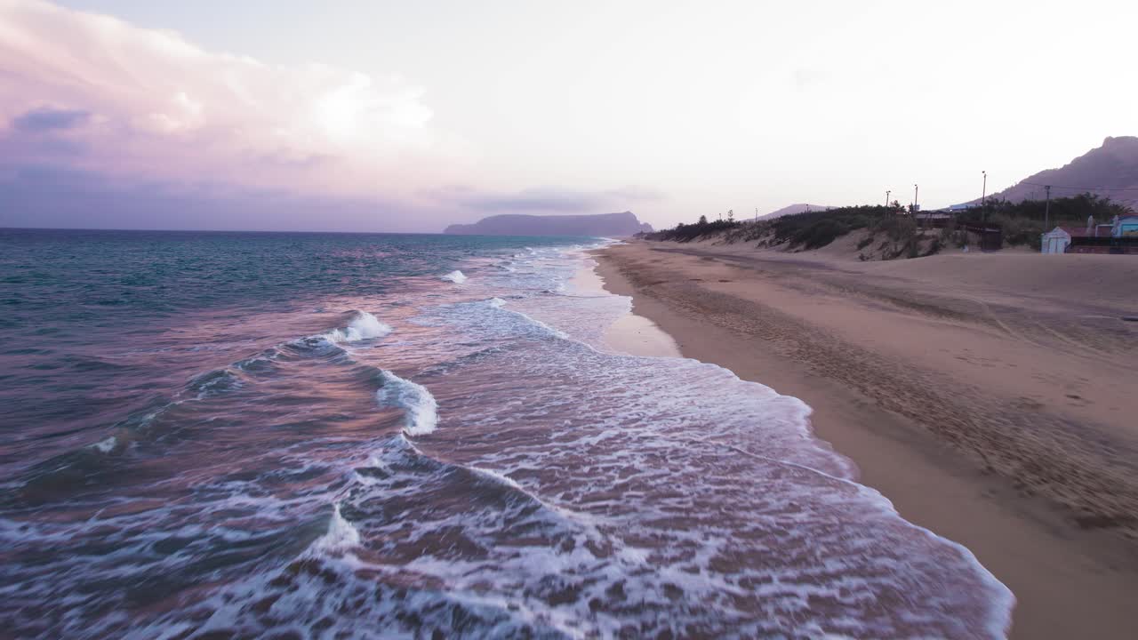 Following aerial view about the Praia da Lagoa coastline at evening, Portugal.
