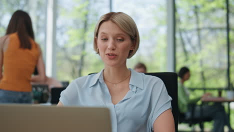 woman trainer talking webinar looking laptop closeup. smiling manager video chat