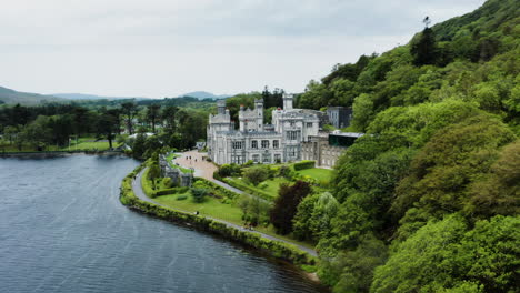 castle kylemore abbey gardens in connemara, galway, ireland - aerial drone