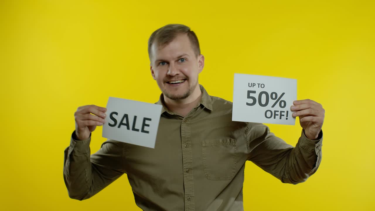 hombre guapo mostrando la palabra de venta y mostrando hasta un 50 por ciento de descuento en la inscripción. concepto de viernes negro