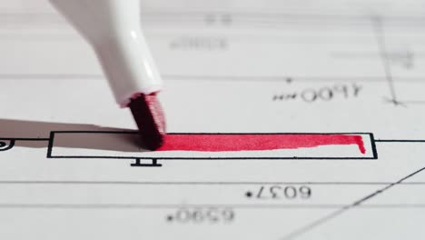 red marker highlighting a technical document