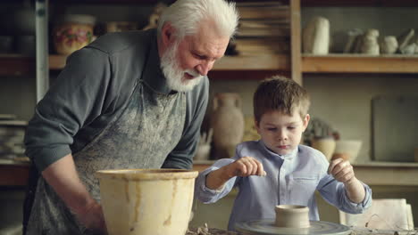 grandpa and grandson making pottery