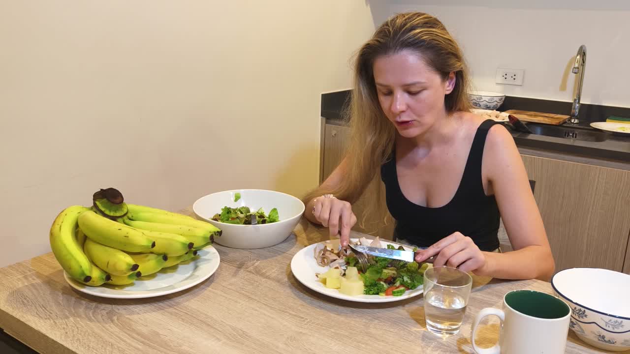 Woman Eating Healthy Meal with Salad and Bananas