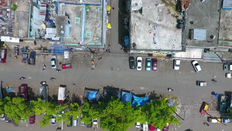 aerial, top down, drone shot over streets, cars, mopeds and buildings, in capotillo district, santo domingo, dominican republic