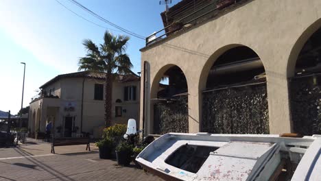 A-boat-leaning-against-a-wall-in-Borghetto-dei-pescatori,-meaning-fisherman-village