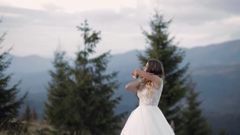 a beautiful bride posing in a mountain forest