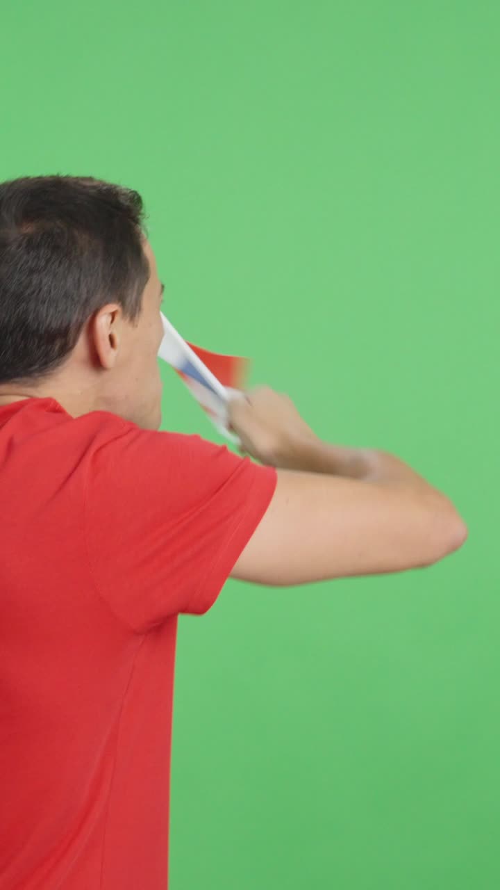 Rear view of a man waving a panamanian pennant