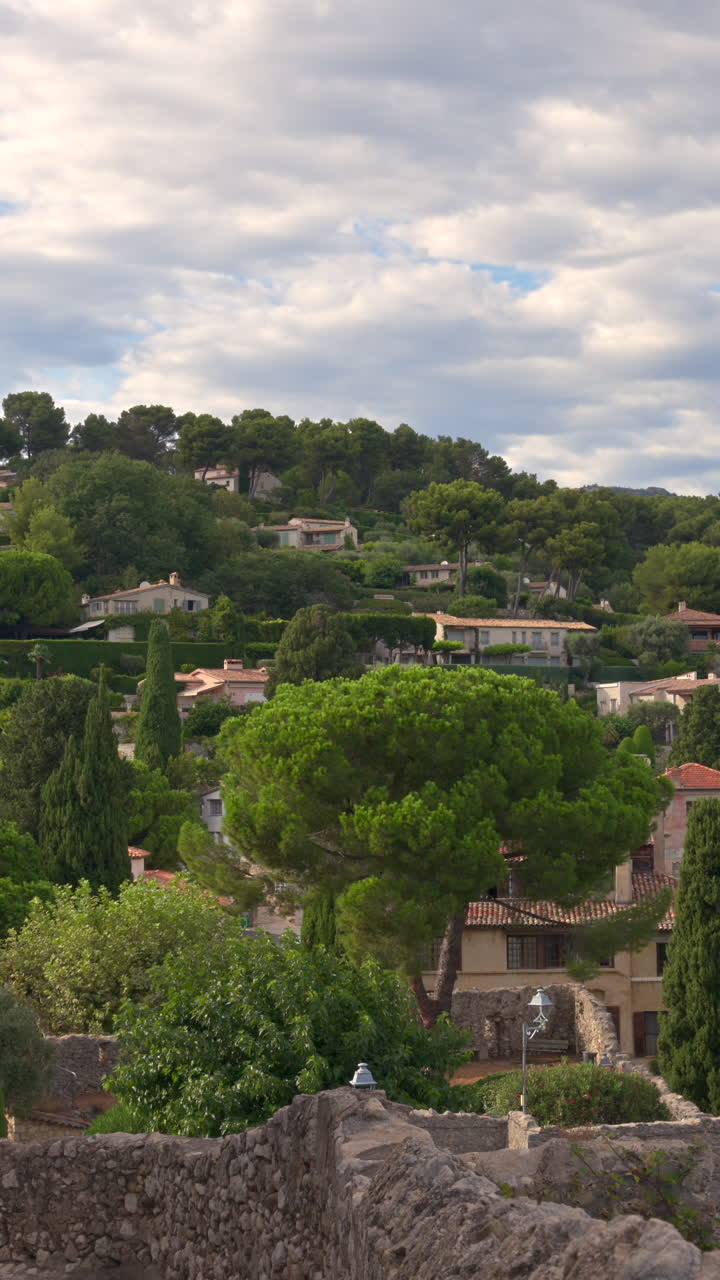 View of the Saint Paul de Vence commune in France with the mountains on the background. Vertical