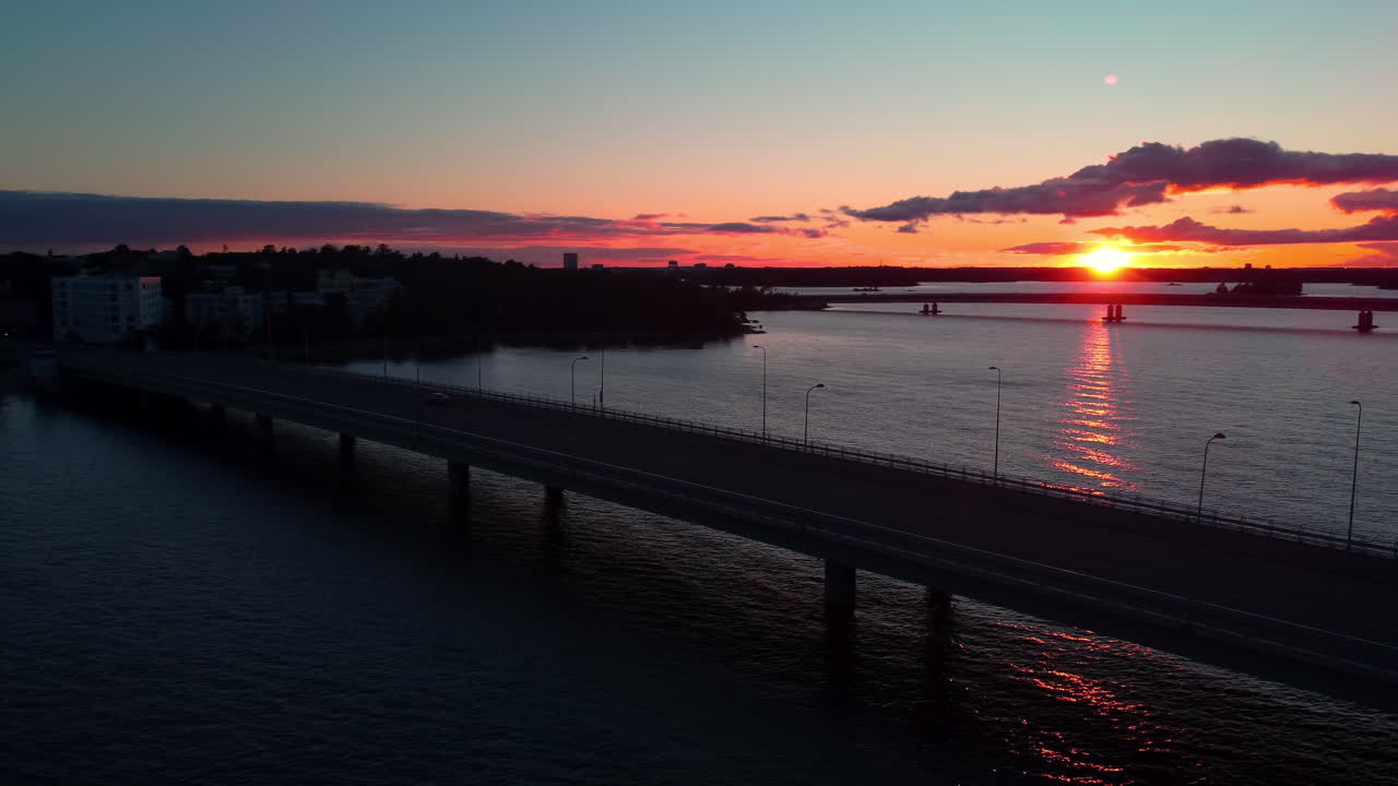 Quiet Lauttasaarensilta bridge, sunset in Helsinki, Finland - circling, aerial
