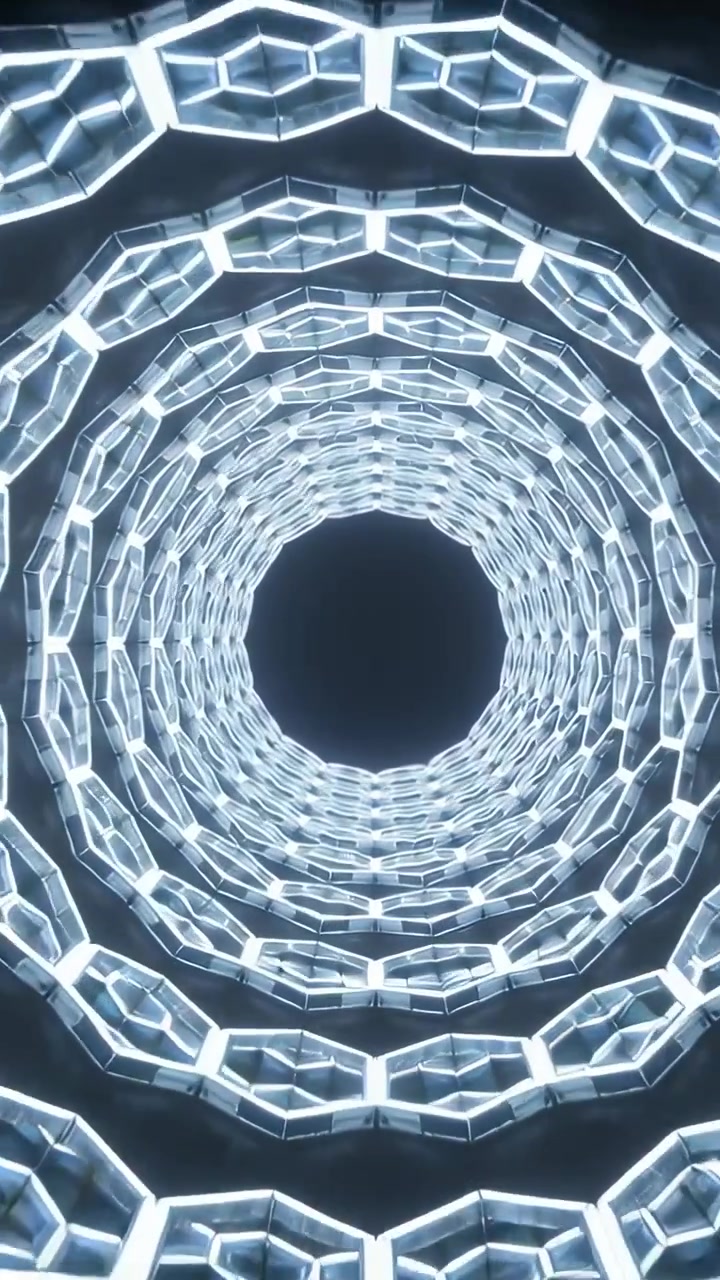 Video verticale: Telecamera che si avvicina con uno zoom ad anelli LED esagonali concentrici in un atrio, rivelando il vuoto.