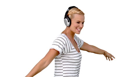 young woman listening to music on white background