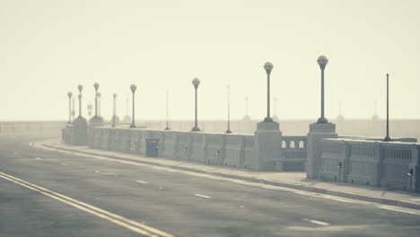 a view of a road with fog and streetlights