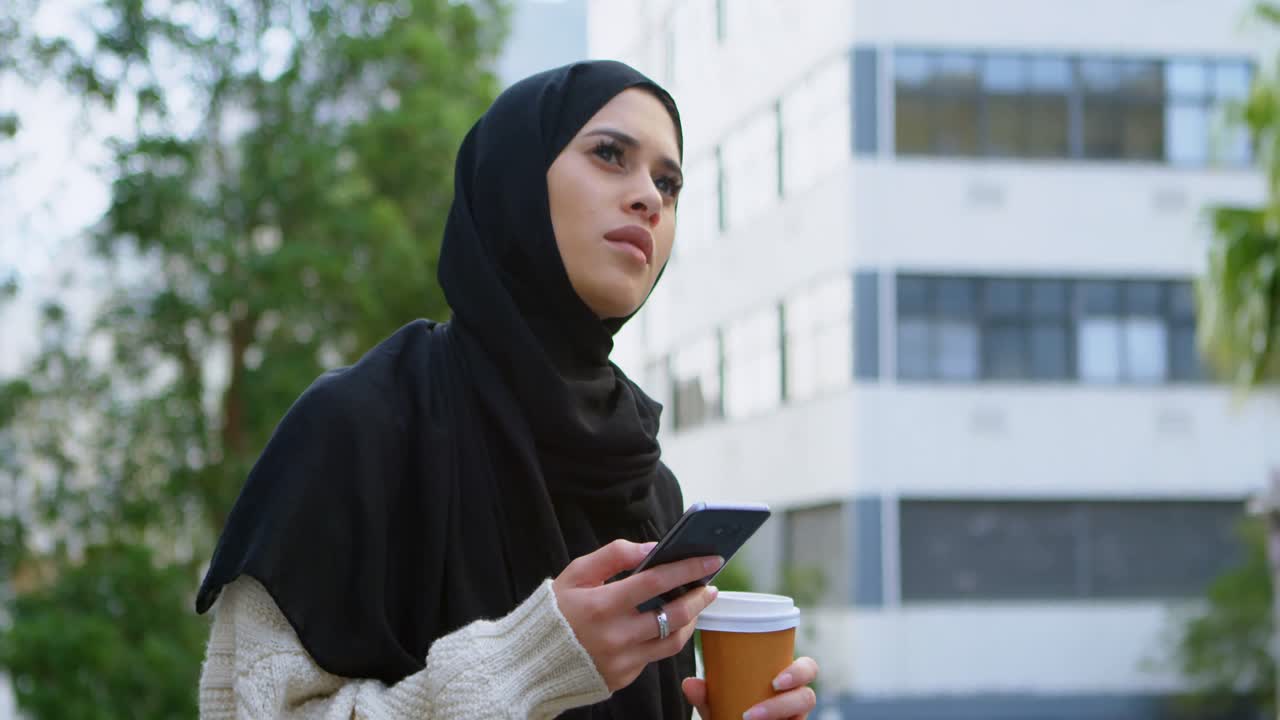 Woman in hijab using mobile phone 4k