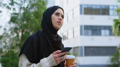 woman in hijab using mobile phone 4k