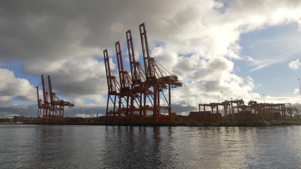 Gantry Cranes For Loading And Unloading At Container Port During A Cloudy Day. POV Shot