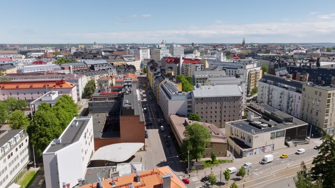 AERIAL: Traffic on the Mechelininkatu street and the cityscape of Kamppi, Helsinki