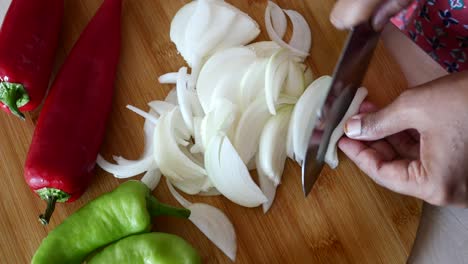 chopping onions and peppers for a delicious meal