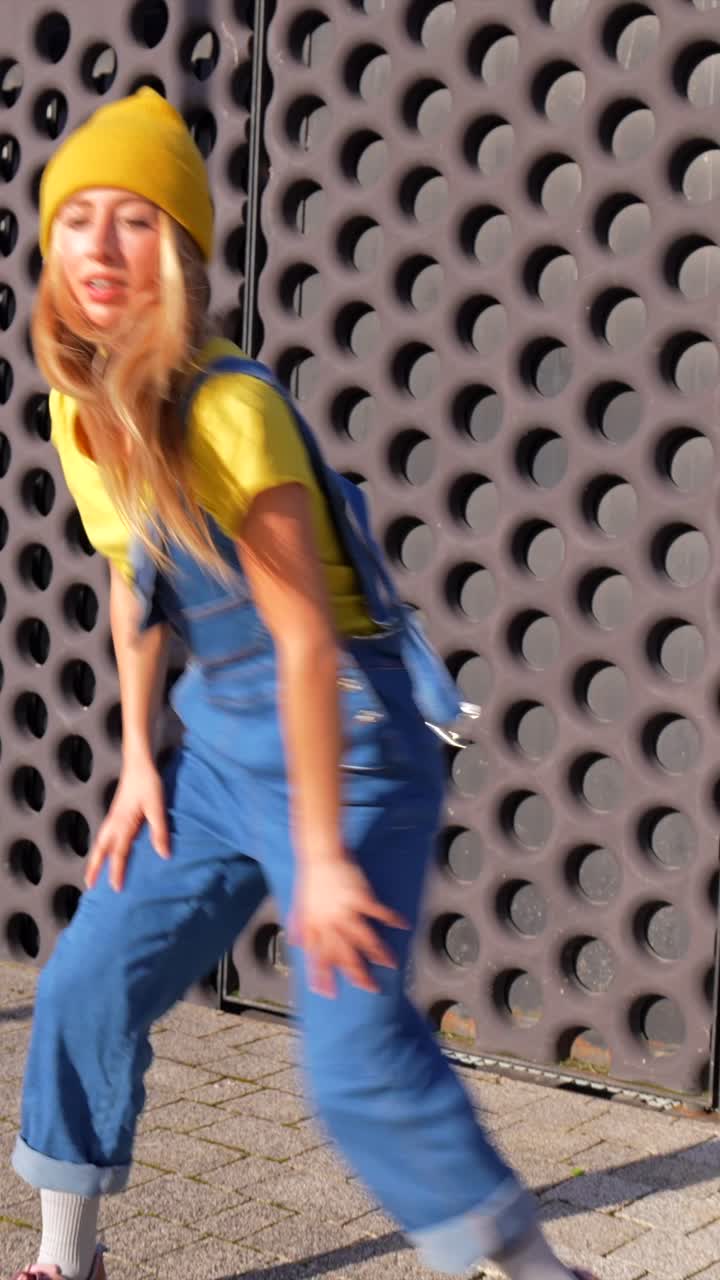 Woman Dancing in Yellow Beanie and Overalls