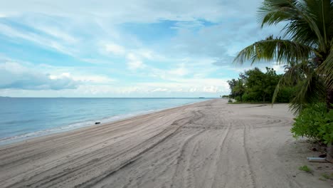 Low-drone-flight-over-beautiful-tropical-beach-in-Malaysia,-Langkawi-Island