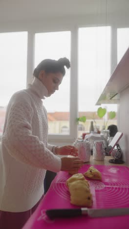 teenage girl baking bread in a kitchen