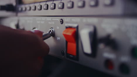 female hand switch toggle on airplane control pane. control buttons