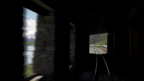 Train-passing-through-Swiss-landscape-into-tunnel