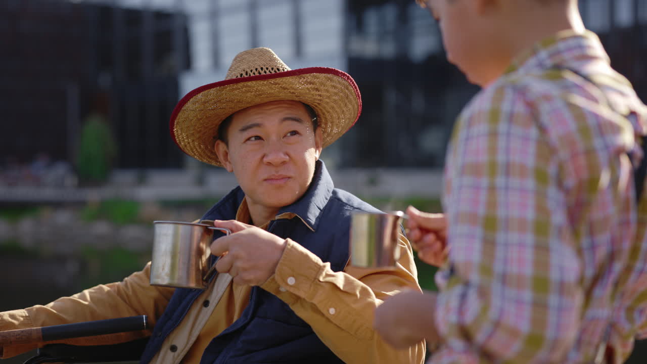 Man in Wheelchair and Son Enjoying a Drink
