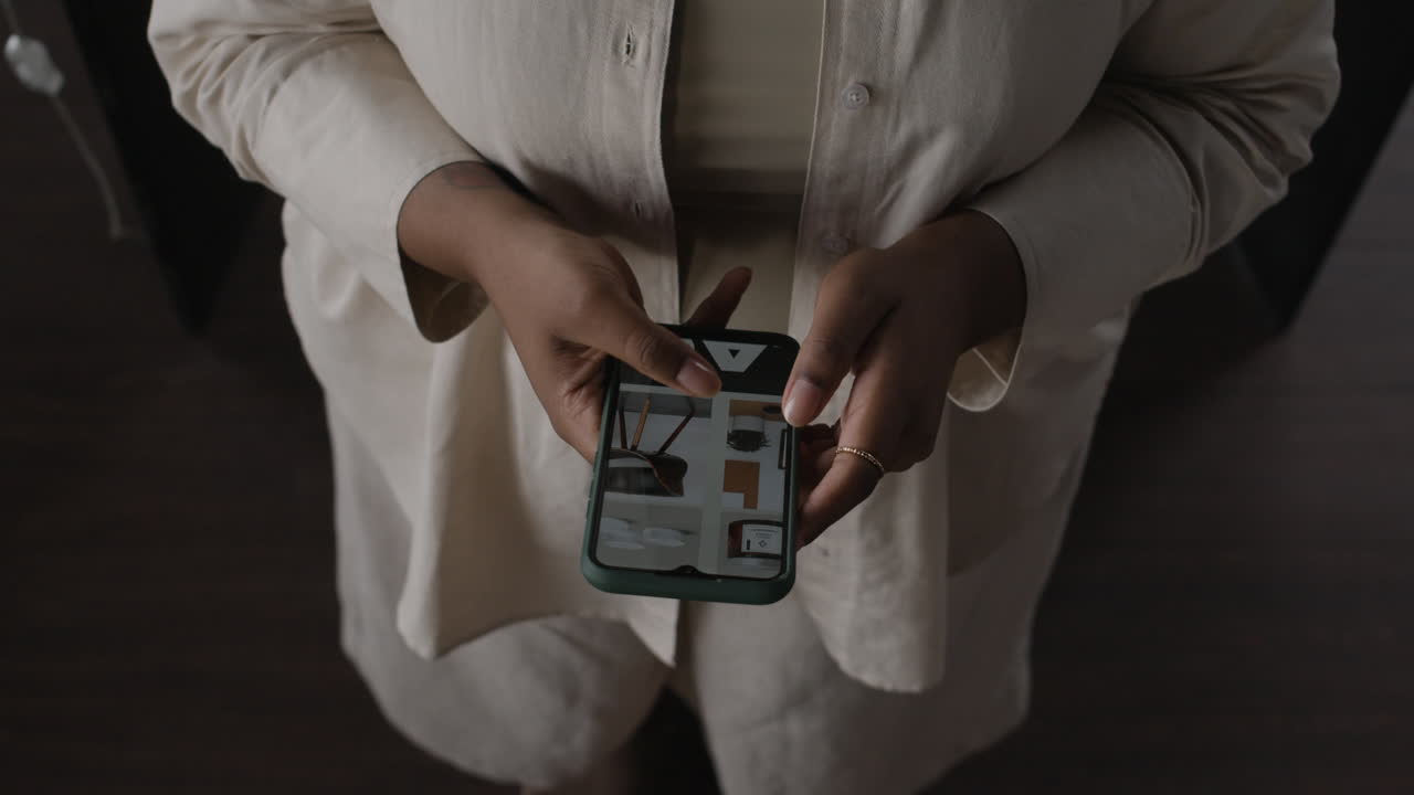 Woman holding phone indoors