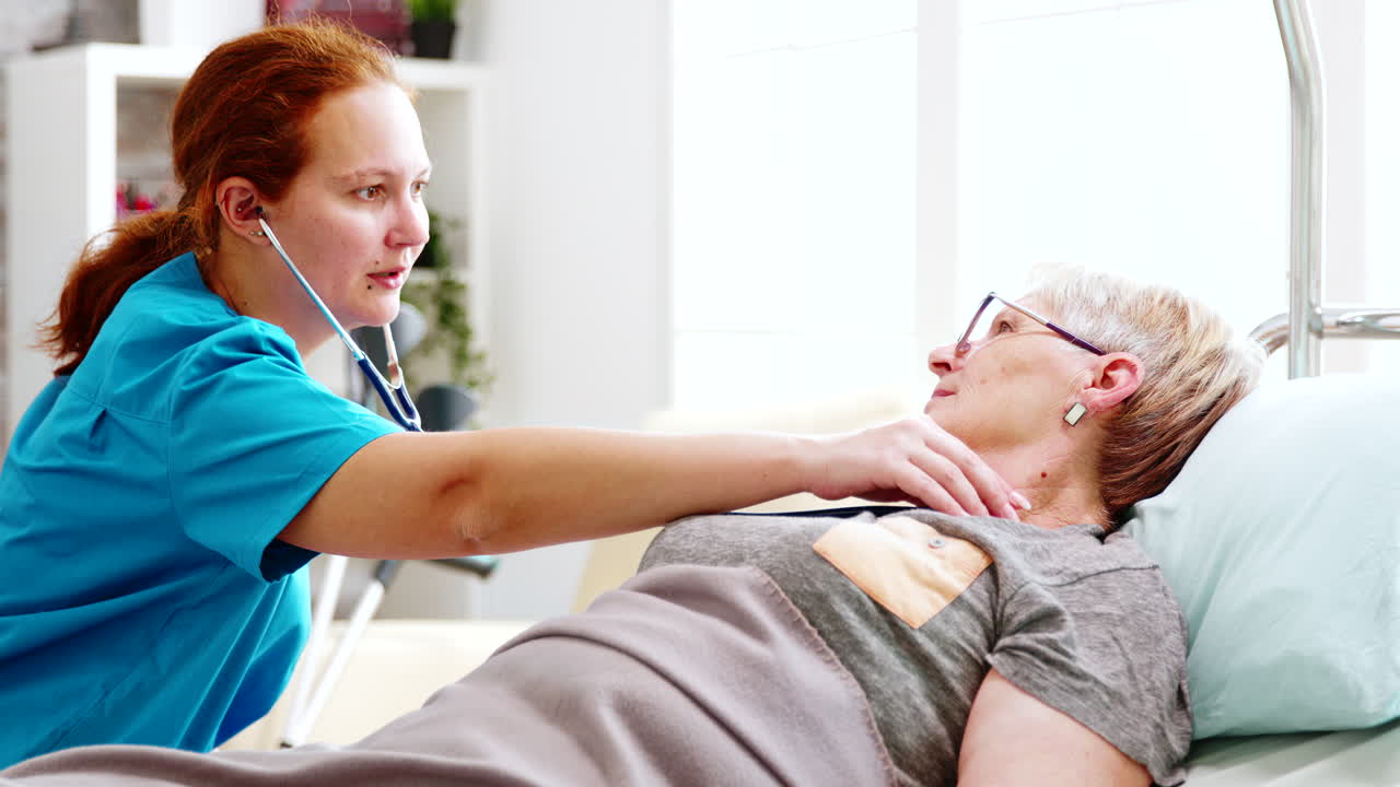 Old lady getting her heartbeats checked by a female nurse