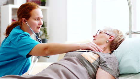 old lady getting her heartbeats checked by a female nurse