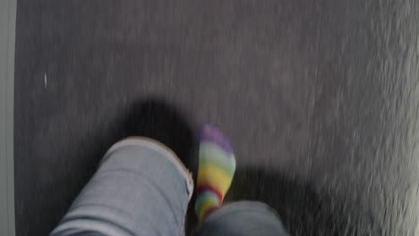 person walking with rainbow striped socks