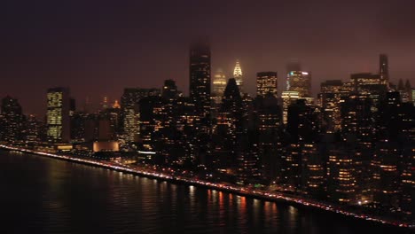 Aerial-pan-across-legendary-New-York-City-skyline-at-foggy-twilight