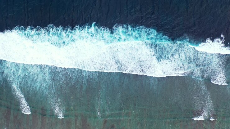 Big white waves of ocean splashing and foaming on colorful shore of tropical coastline in Hawaii, copy space with sea texture