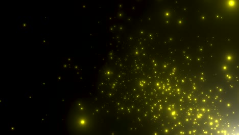 pequeñas partículas amarillas y estrellas en fondo oscuro