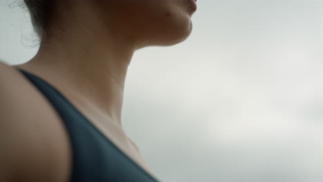 Peaceful-woman-meditating-gloomy-day-close-up.-Girl-close-eyes-practicing-yoga.