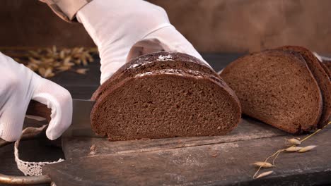 el chef corta pan de lechuga casera en rebanadas con un cuchillo de cocina. primer plano