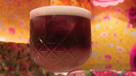 purple cocktail in a fancy glass