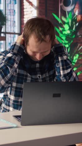 Vertical video Exhausted freelancer feeling overworked while typing on device keyboard