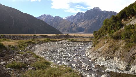 stream running through mountains in red tarns track, mount cook in south island, new zealand - wide shot