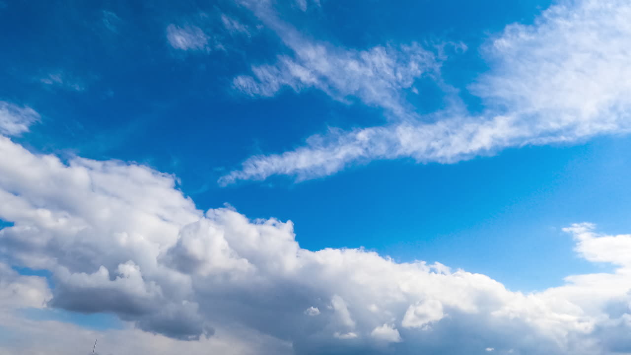 Amazing azure sky with cirro-cumulus white clouds. Light clouds change into heavy grey once. Low angle view. Timelapse.