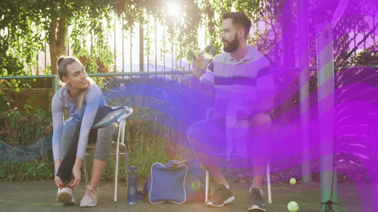 Sitting outdoors, two people with colorful wave animation overlay, relaxing together